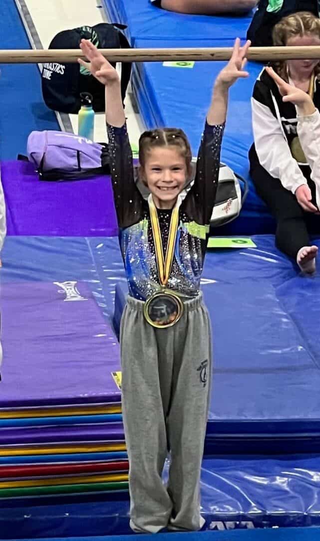 Gymnast with medal in a Salute pose
