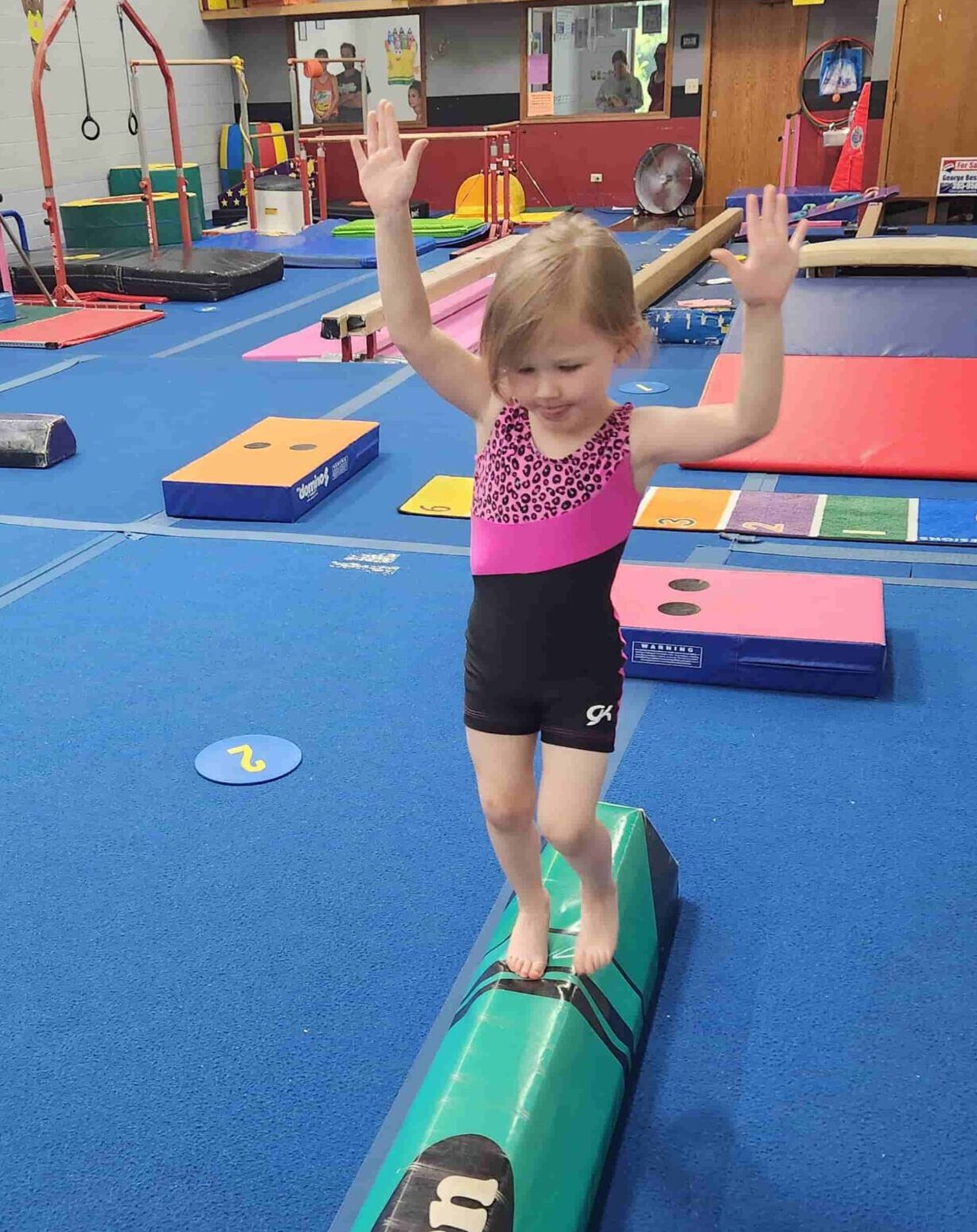 Young gymnast works on skills on balance beam